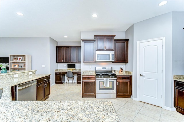 kitchen with light stone counters, stainless steel appliances, recessed lighting, dark brown cabinets, and baseboards