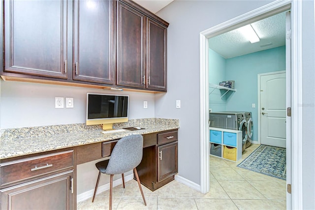 office area featuring light tile patterned floors, built in desk, a textured ceiling, and baseboards