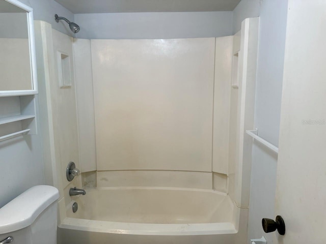 bathroom featuring tub / shower combination and toilet