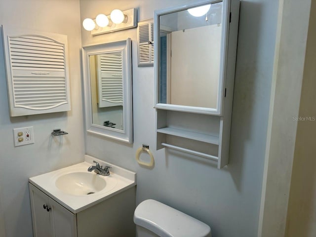 half bath featuring toilet and vanity