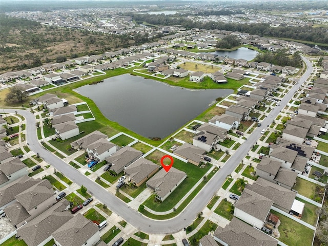 birds eye view of property with a water view and a residential view