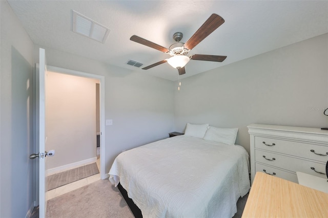 bedroom with baseboards, visible vents, and a ceiling fan