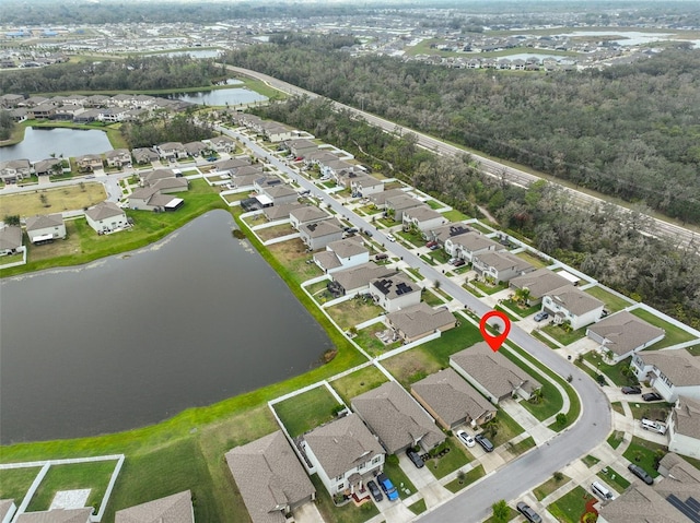 birds eye view of property with a water view and a residential view