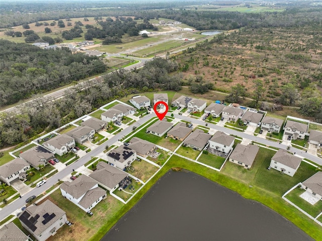 birds eye view of property with a water view and a residential view