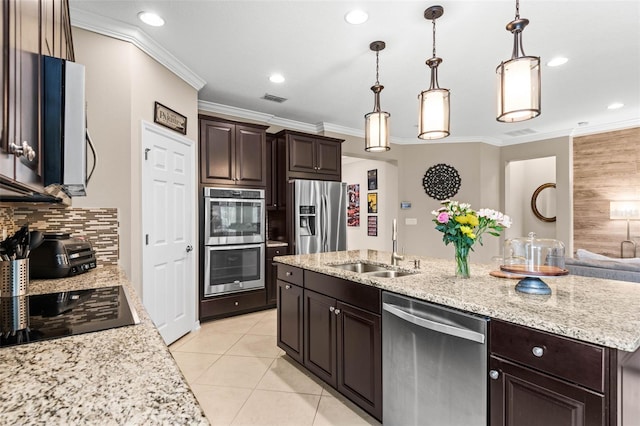 kitchen featuring dark brown cabinets, visible vents, stainless steel appliances, and a sink