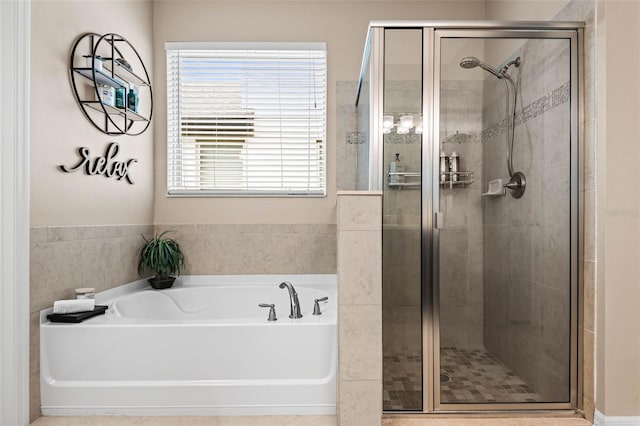 bathroom with a garden tub and a shower stall