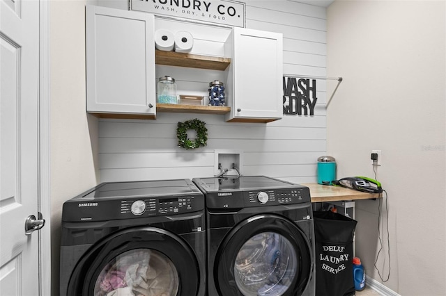 washroom featuring cabinet space and independent washer and dryer