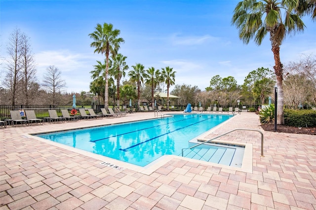 pool featuring a patio area and fence