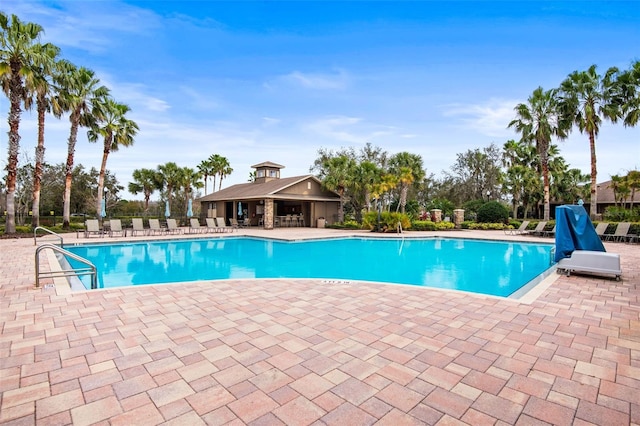 community pool featuring a patio area and fence