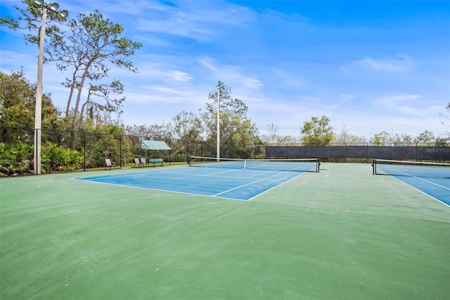 view of sport court with fence