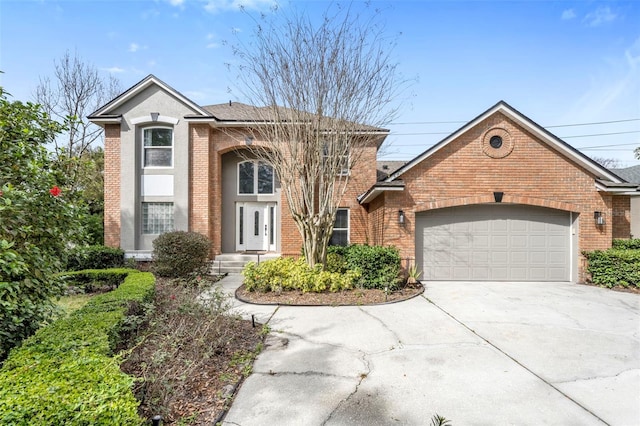 traditional-style home with a garage, driveway, and brick siding