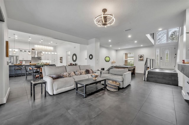 living room with recessed lighting, stairway, and baseboards