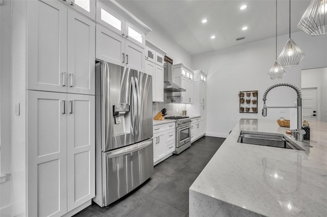 kitchen featuring glass insert cabinets, appliances with stainless steel finishes, white cabinets, and a sink