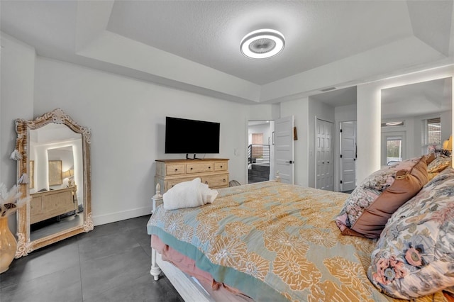 bedroom featuring baseboards and a tray ceiling