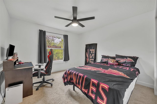 carpeted bedroom with baseboards and a ceiling fan