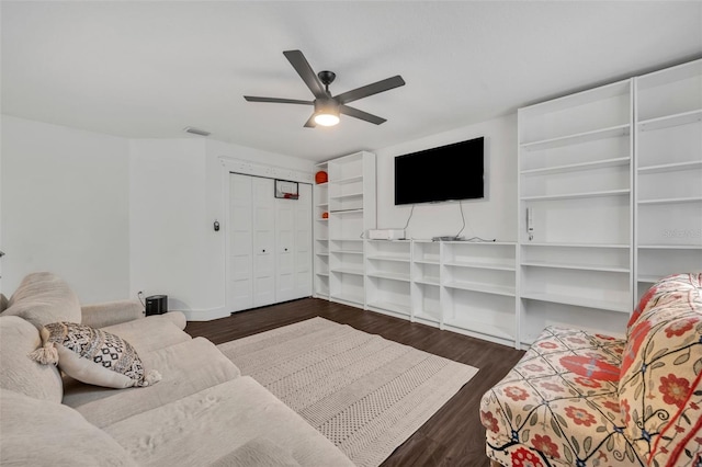 living area featuring dark wood-type flooring, visible vents, and a ceiling fan