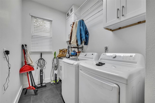 laundry area with washing machine and dryer, cabinet space, and baseboards