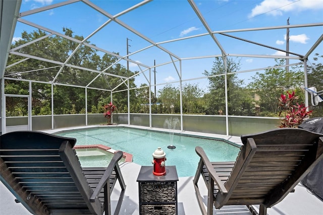 pool featuring a patio area, glass enclosure, a water view, and a jacuzzi