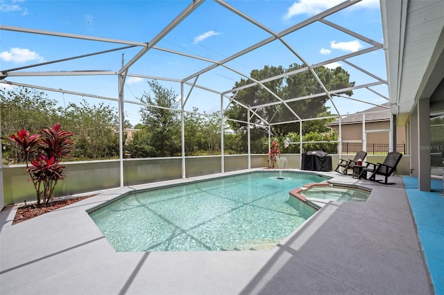 view of pool featuring a lanai, a pool with connected hot tub, and a patio