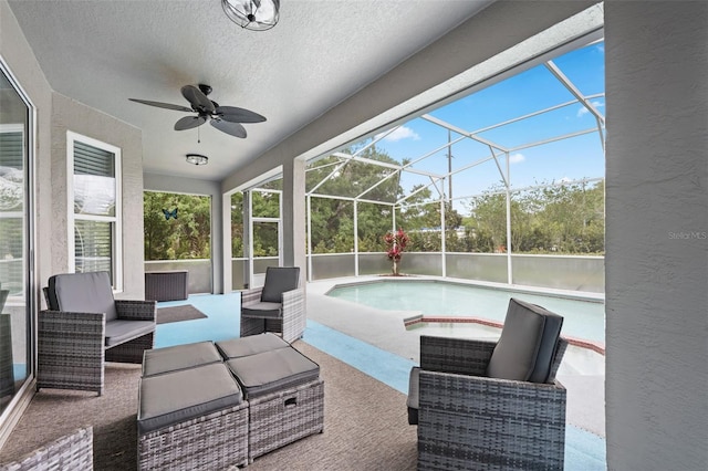 sunroom featuring a ceiling fan