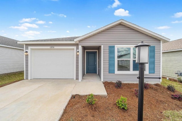 single story home with a garage and driveway