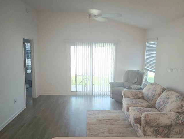 living room with lofted ceiling, ceiling fan, and dark wood finished floors