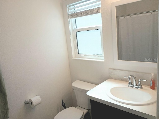 bathroom with vanity and toilet