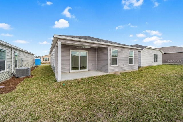 rear view of property featuring a yard, a patio, and central air condition unit