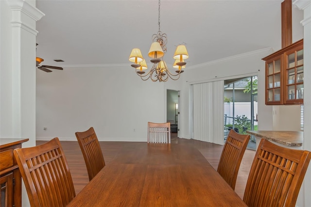 dining room with ornamental molding, dark wood-type flooring, ceiling fan with notable chandelier, and baseboards