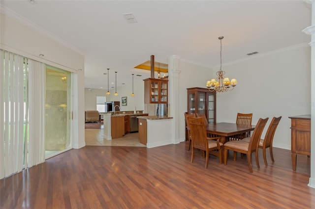 dining space with ornamental molding, visible vents, and light wood finished floors