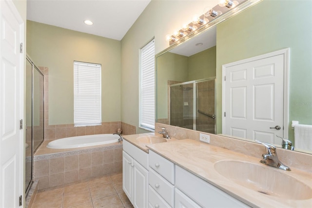 bathroom featuring tile patterned flooring, a sink, a bath, and a shower stall