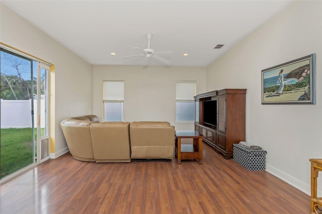 living area with recessed lighting, visible vents, baseboards, and wood finished floors