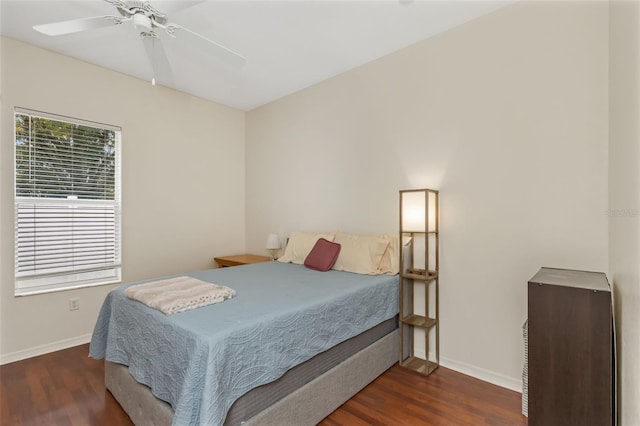 bedroom featuring dark wood-style flooring, ceiling fan, and baseboards