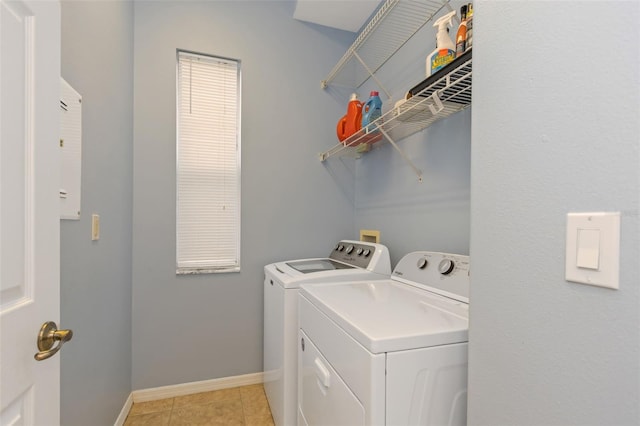 washroom with light tile patterned floors, laundry area, independent washer and dryer, and baseboards