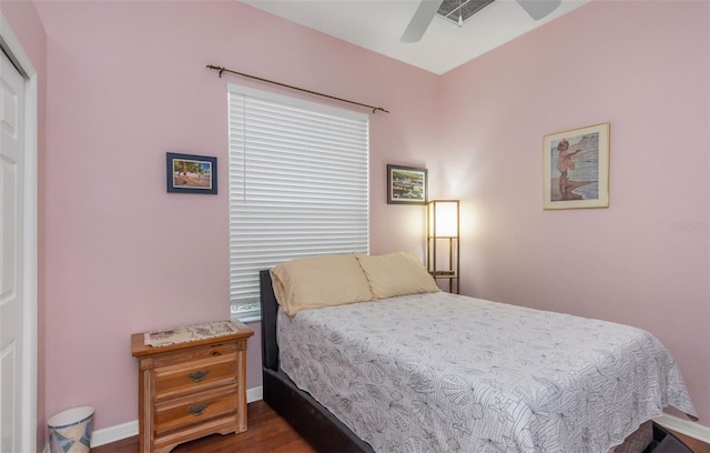 bedroom featuring a ceiling fan, baseboards, and wood finished floors