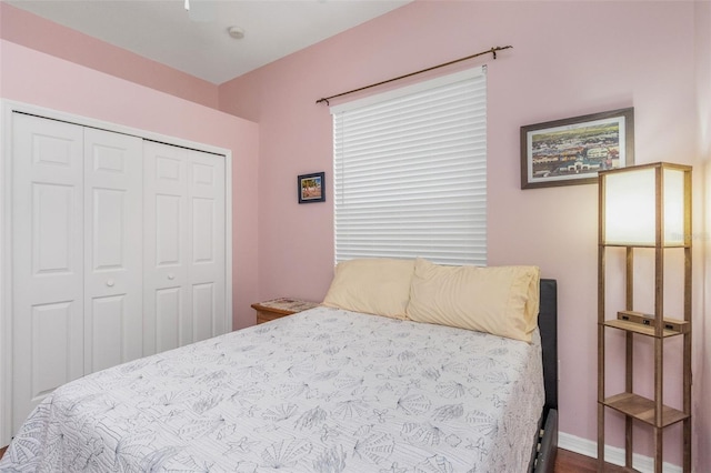 bedroom featuring a closet and baseboards