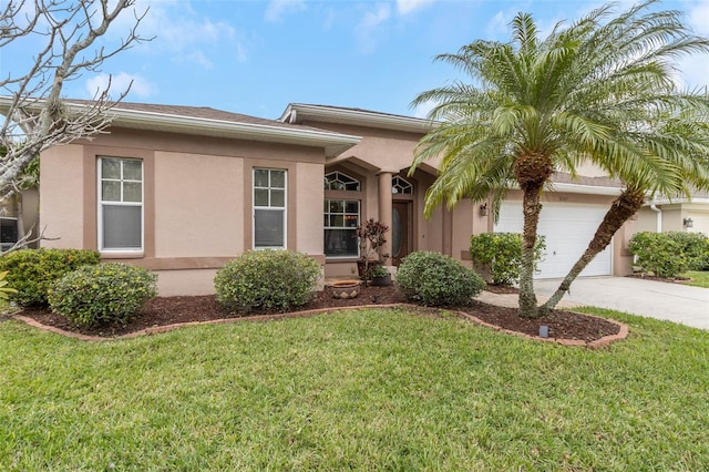 ranch-style home with a front yard, driveway, an attached garage, and stucco siding