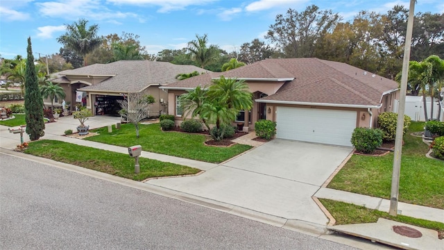 view of front of house featuring a garage, concrete driveway, roof with shingles, a front lawn, and stucco siding