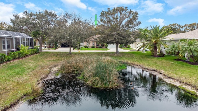 view of yard with a water view and a lanai