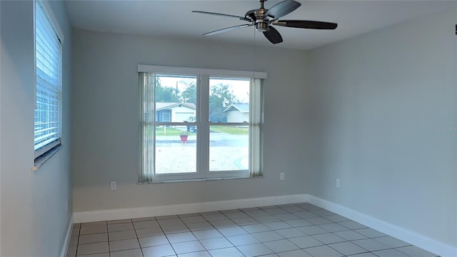 unfurnished room featuring light tile patterned floors, baseboards, and a ceiling fan