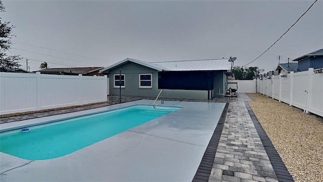 view of pool featuring a patio area, a fenced backyard, and a fenced in pool