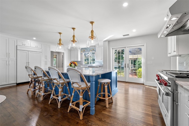 kitchen featuring tasteful backsplash, visible vents, high quality appliances, ventilation hood, and french doors