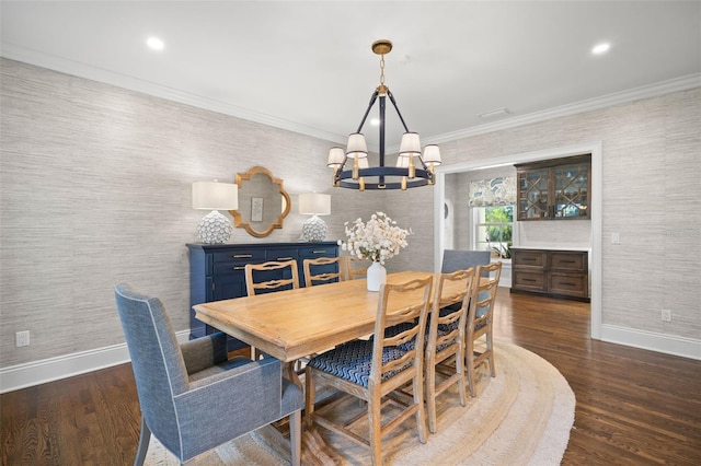 dining room with an inviting chandelier, baseboards, dark wood-type flooring, and ornamental molding