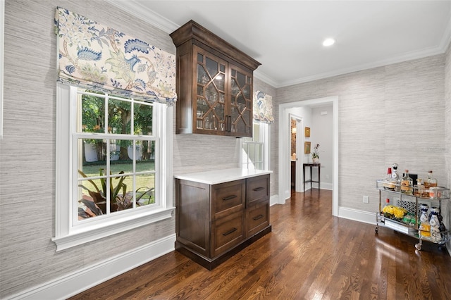 bar featuring ornamental molding, dark wood-style flooring, and baseboards