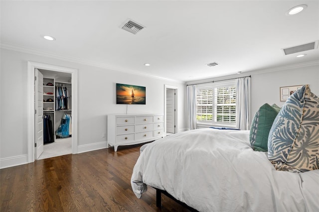 bedroom with ornamental molding, visible vents, and wood finished floors