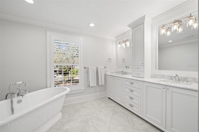 bathroom with double vanity, a soaking tub, ornamental molding, a sink, and baseboards