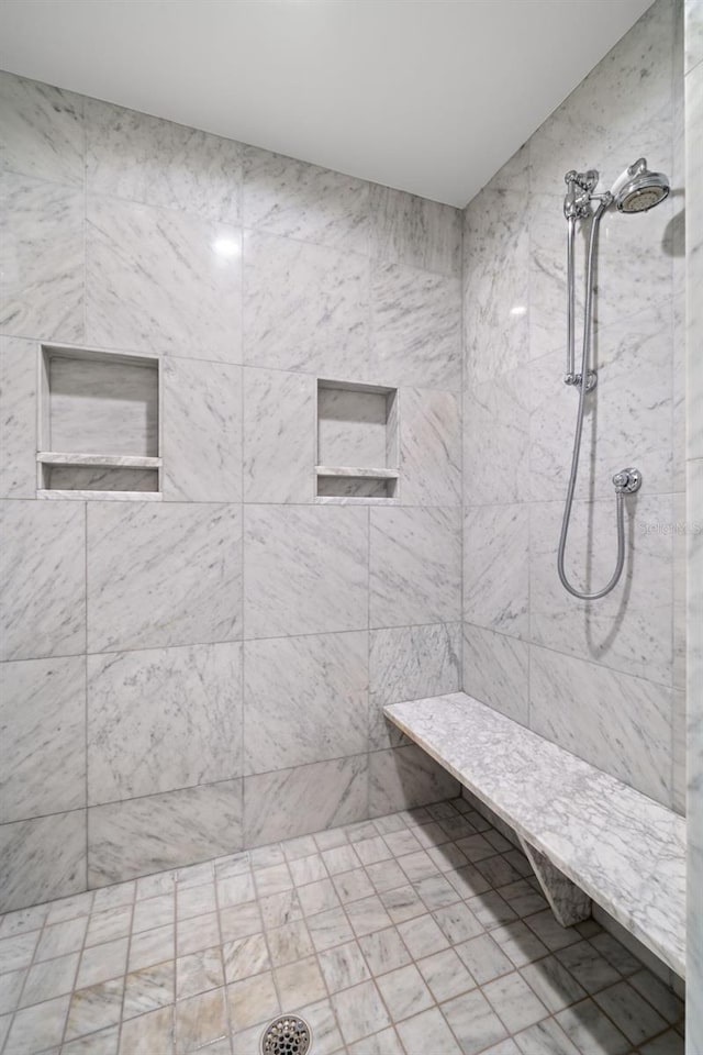 bathroom with tiled shower