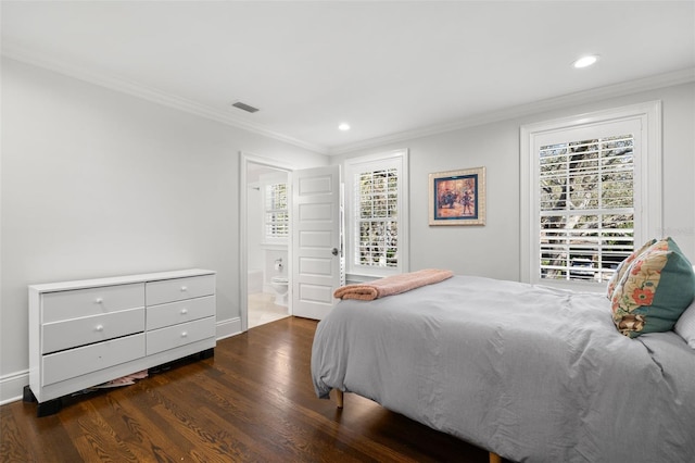 bedroom featuring wood finished floors, visible vents, crown molding, and multiple windows