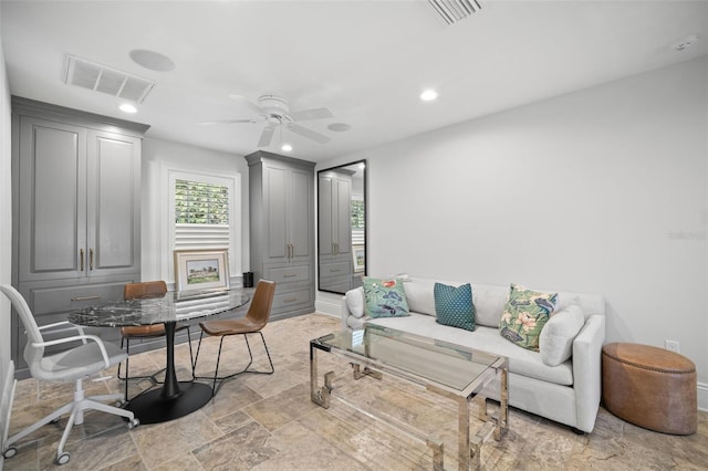 living area featuring stone finish flooring, visible vents, a ceiling fan, and recessed lighting