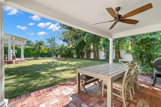 view of patio with ceiling fan, outdoor dining area, a fenced backyard, and a fenced in pool